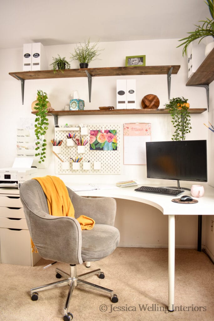 corner desk with an Alex unit, floating shelves, and plants