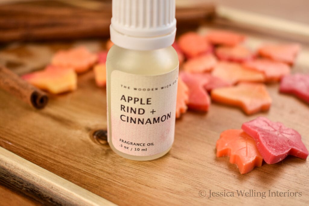 apple cider scented fragrance oil in front of fall leaf-shaped wax melts