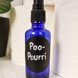 glass spray bottle of DIY Poo-Pourri toilet spray