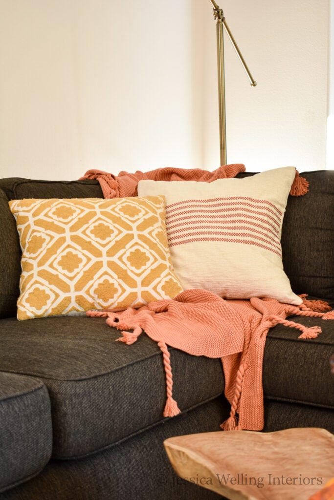 sofa with orange pillow cover and yellow pillow cover for fall