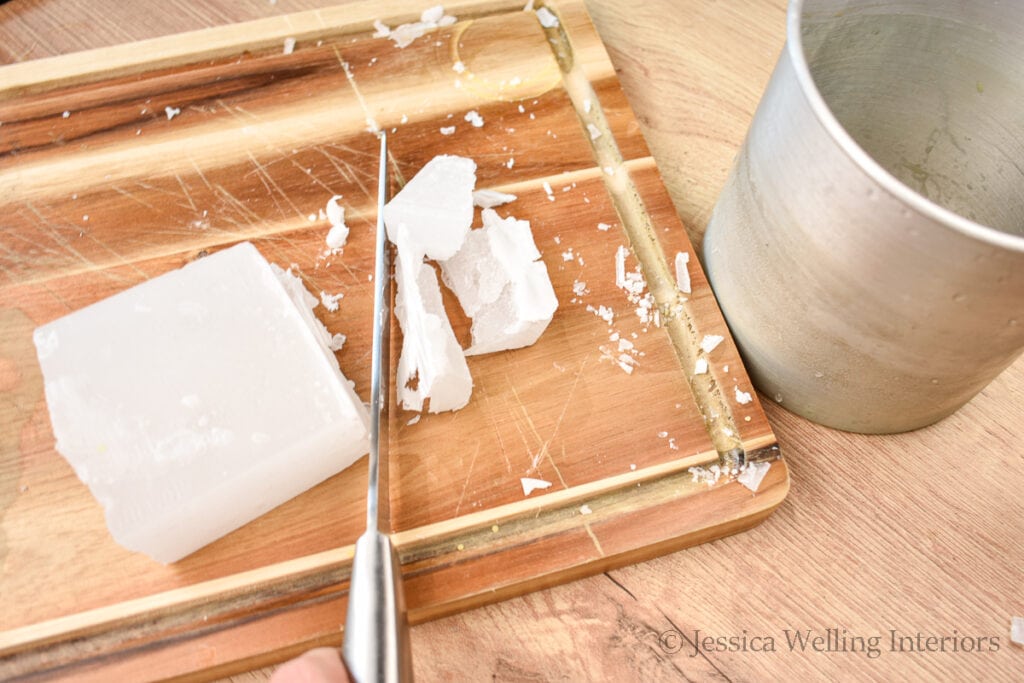 overhead view of a block of paraffin wax being cut with a knife