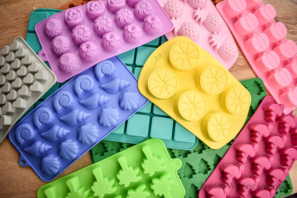 pile of silicone wax melt molds in different shapes
