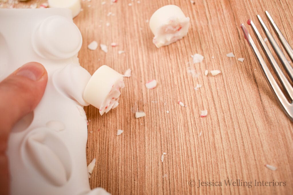 wax melts being removed from a silicone candy mold