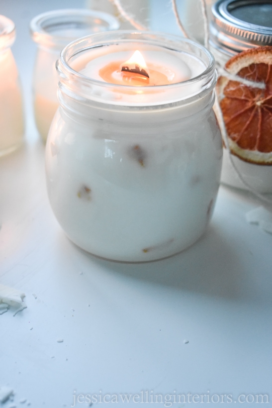 burning handmade soy candle in a glass jar
