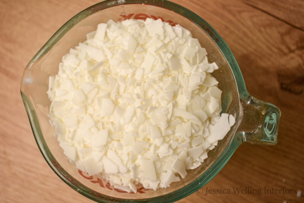 close-up of glass measuring cup of soy wax flakes