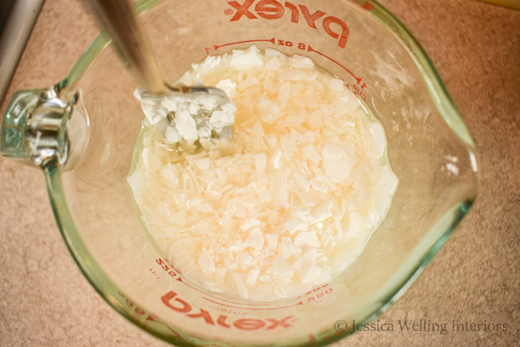 soy wax being melted in a glass measuring cup