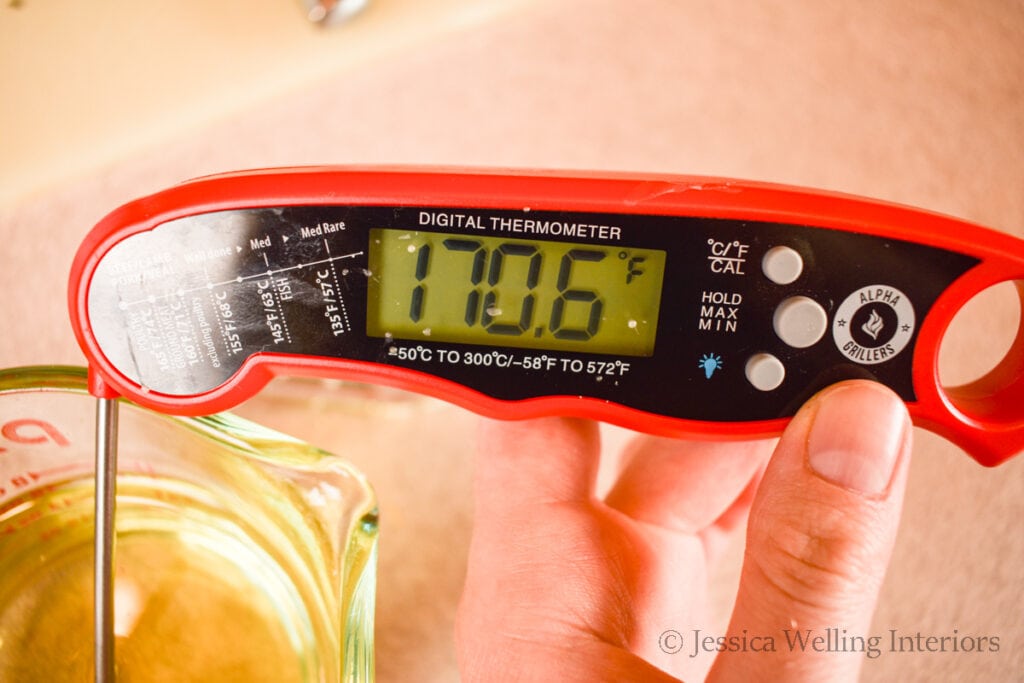 digitial thermometer in a container of melted wax that reads 170 degrees