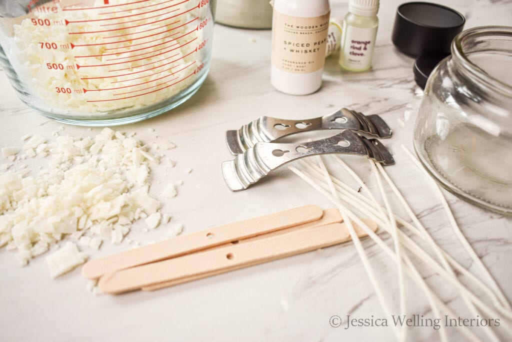 candle making supplies on a countertop- soy wax, wicks, fragrance oils, etc.