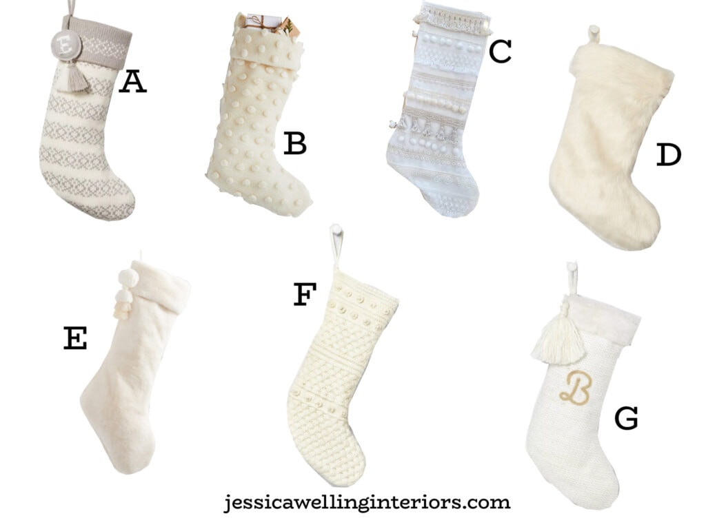collection of white Christmas stockings with tassels, pom poms, embroidery, and faux fur