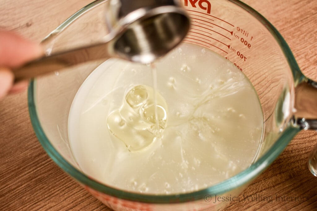 jojoba oil being poured into DIY bubble bath