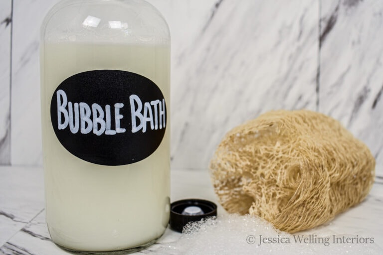 bottle of homemade bubble bath with a loofa sponge