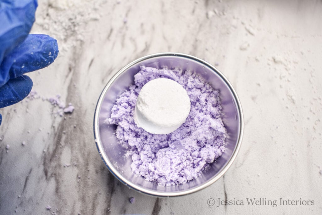 bath bomb mold partially filled with a bath bomb embed on top