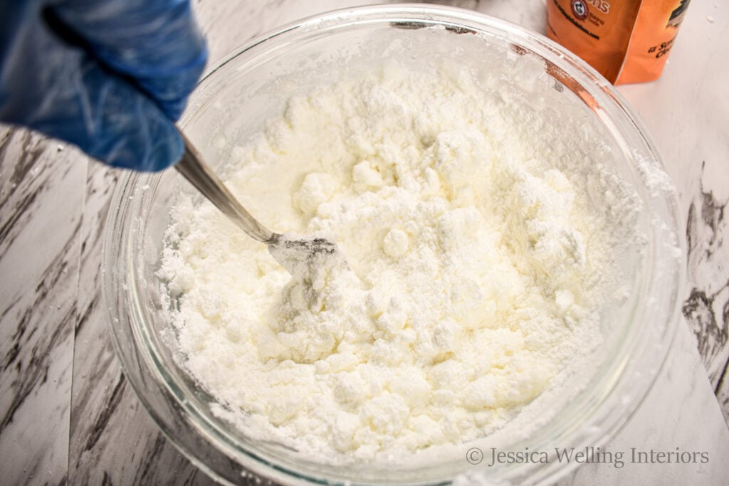 bath bomb ingredients being stirred with a fork