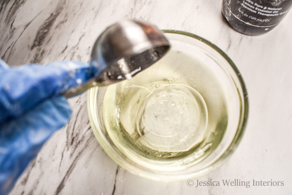 vitamin E oil being poured into a small glass bowl