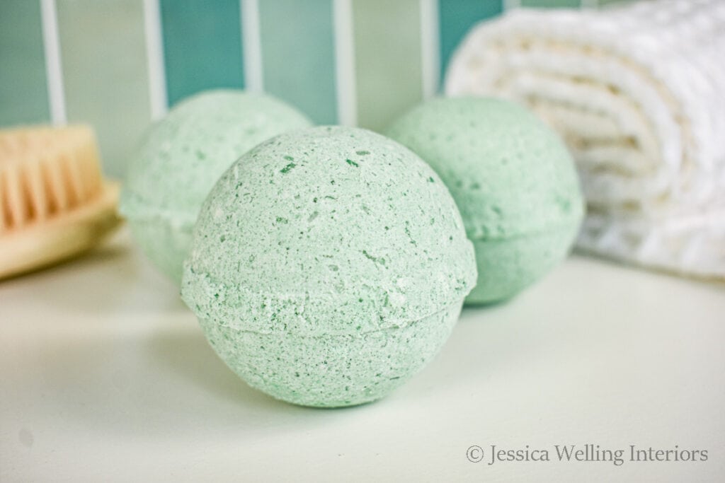 all natural bath bombs sitting on the edge of the tub