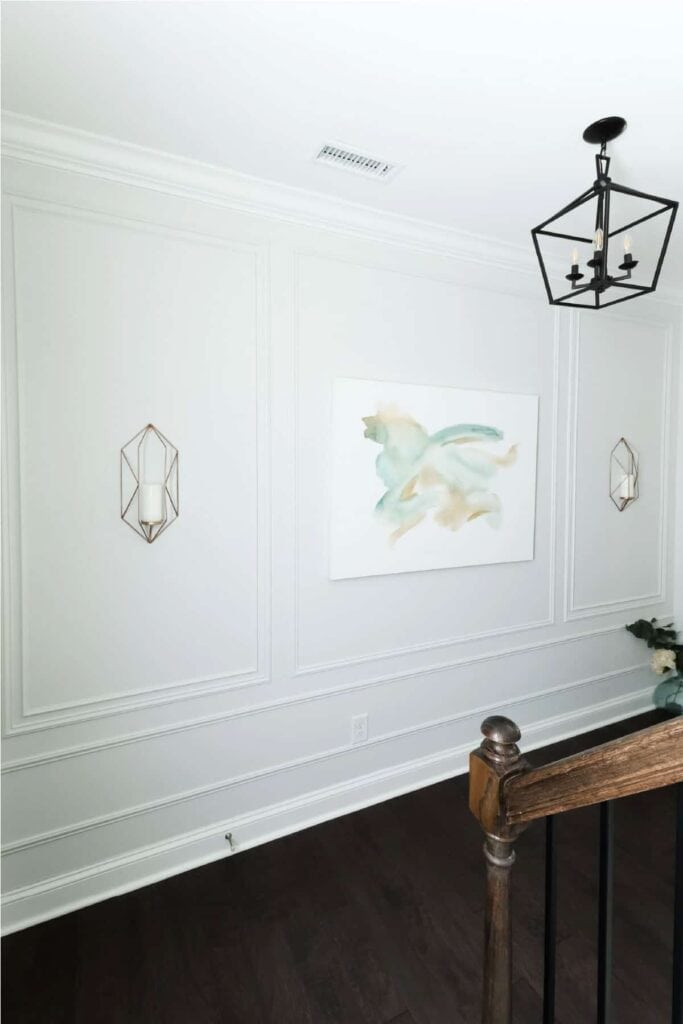 hallway with a classic DIY picture frame molding accent wall in white