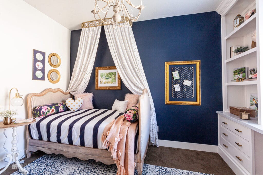 girls' bedroom with a navy blue accent wall
