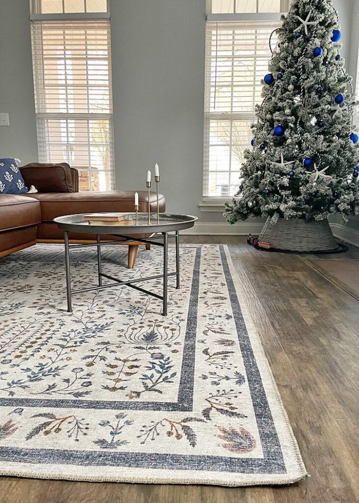 family room with a Christmas tree and large area rug under the sofa and coffee table