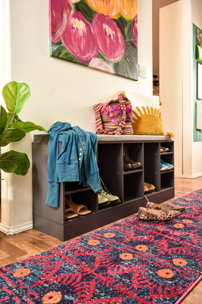 colorful entryway with a shoe storage bench