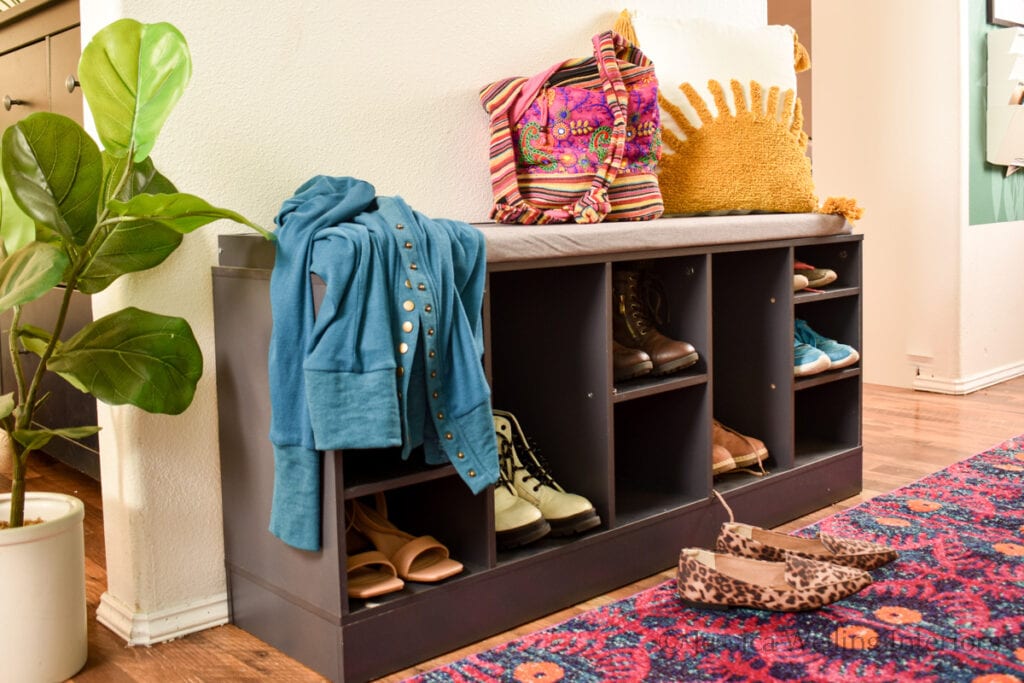 colorful entryway with a shoe bench and purple runner rug