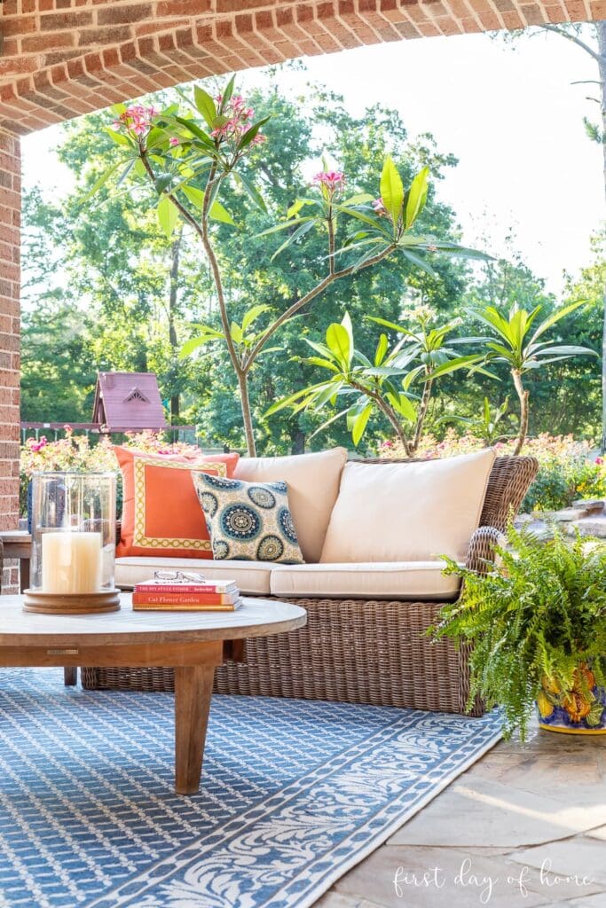 outdoor living room with an outdoor coffee table in front of a patio sofa