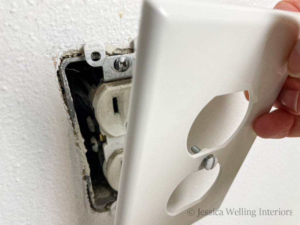 outlet cover being removed