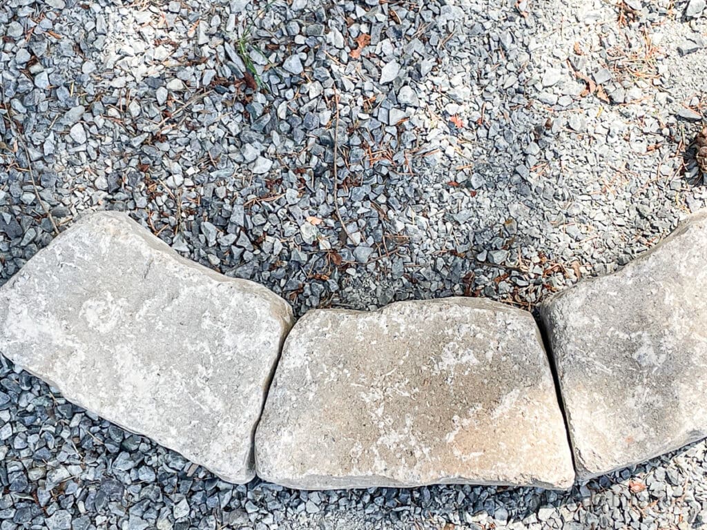 overhead view of three concrete blocks lines up to form the base of a DIY fire pit