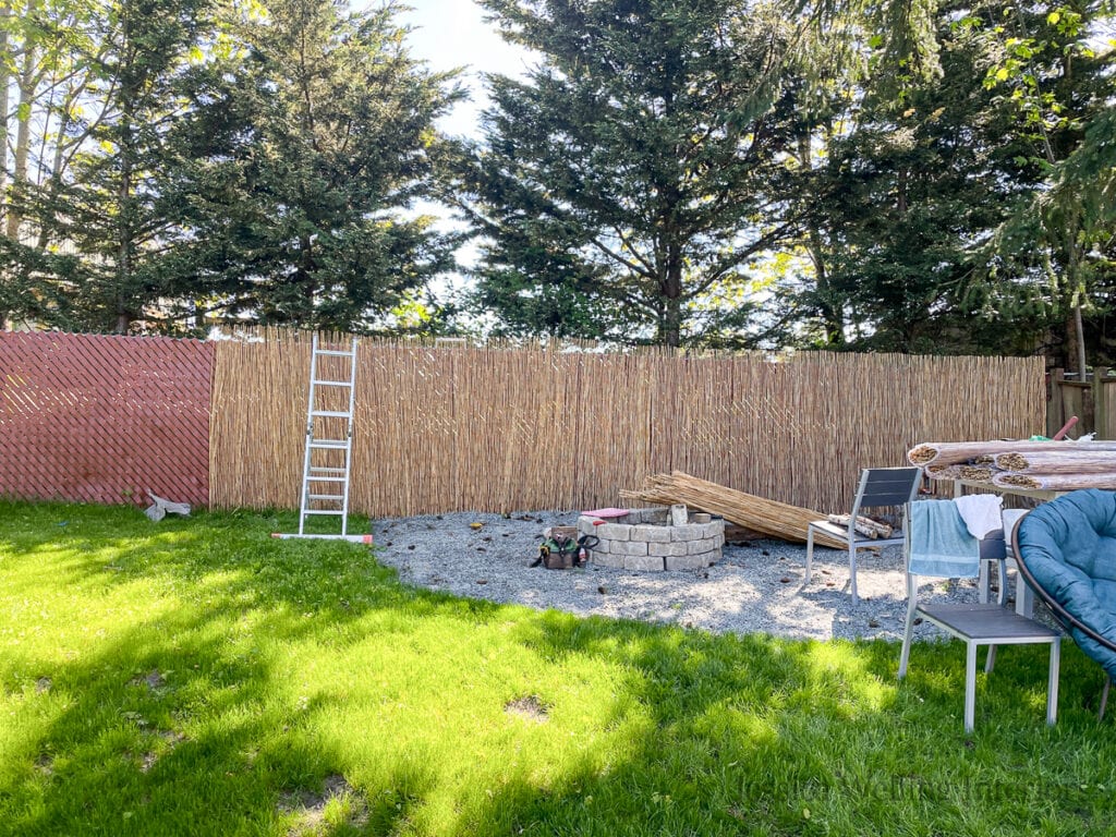 ugly chain-link fence partially covered with bamboo privacy screening