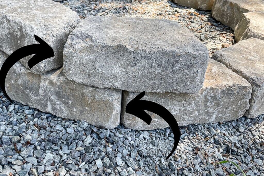 close-up of concrete blocks stacked two-high with arrows