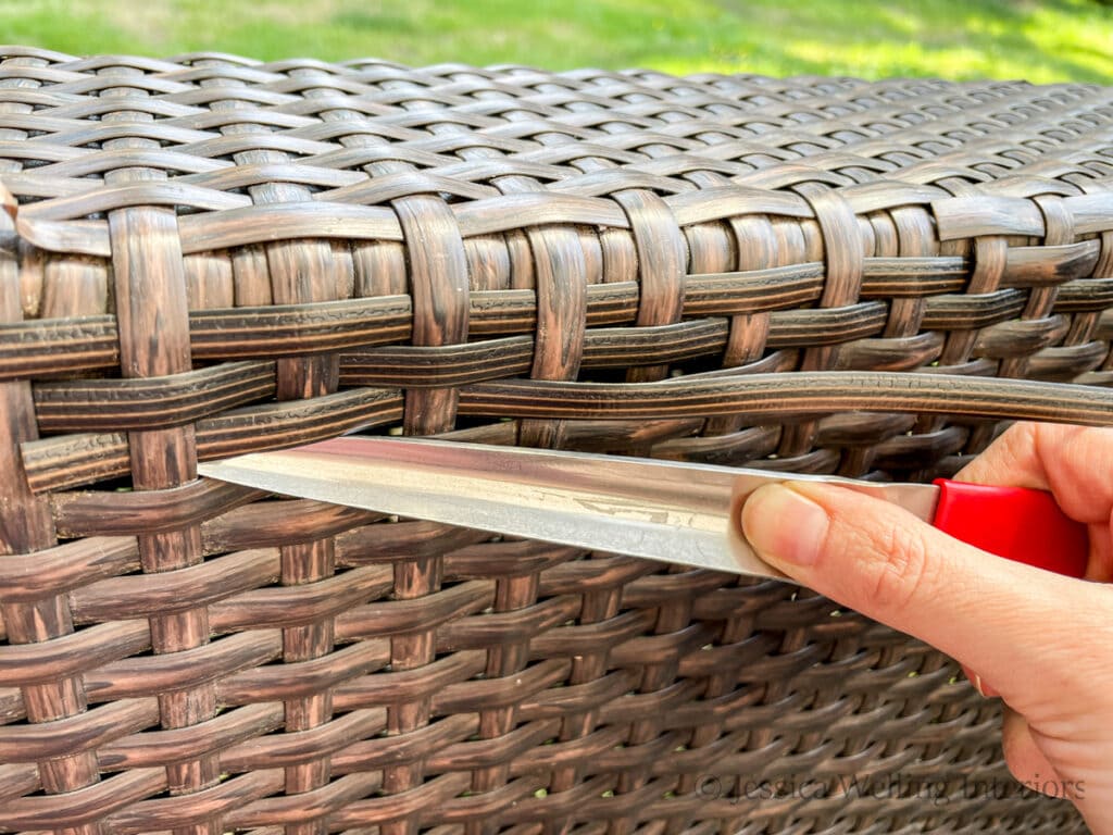 metal weaving tool being used to weave a resin wicker replacement reed to repair outdoor furniture