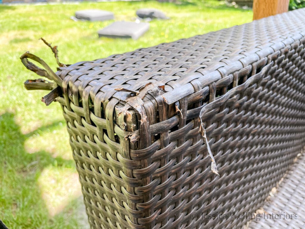 close-up of the damaged arm of an all weather wicker outdoor sofa