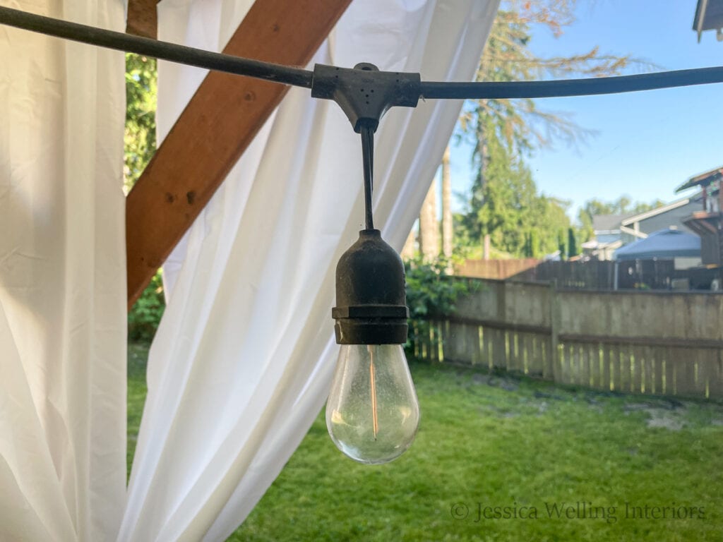 close-up of a heavy duty string light cord, showing that the bulb hangs down about 6" from the cord 