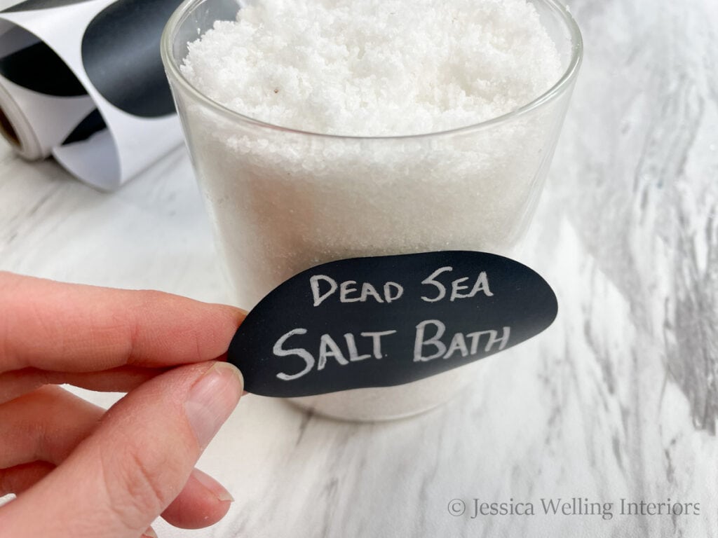 sticker label being applied to a jar of homemade Dead Sea Salt Bath