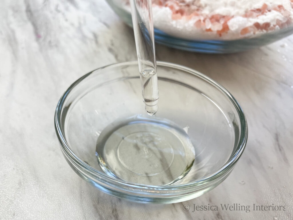 close-up shot of an eye dropper dropping essential oils into a small bowl