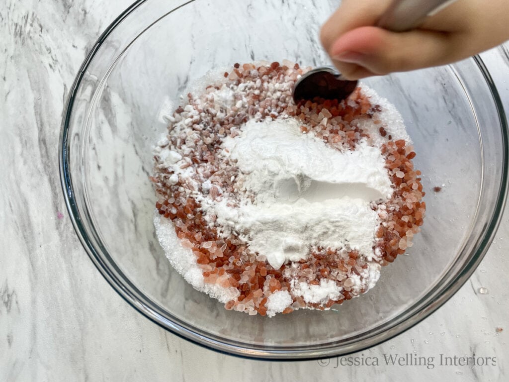 bath salt ingredients being mixed with a spoon