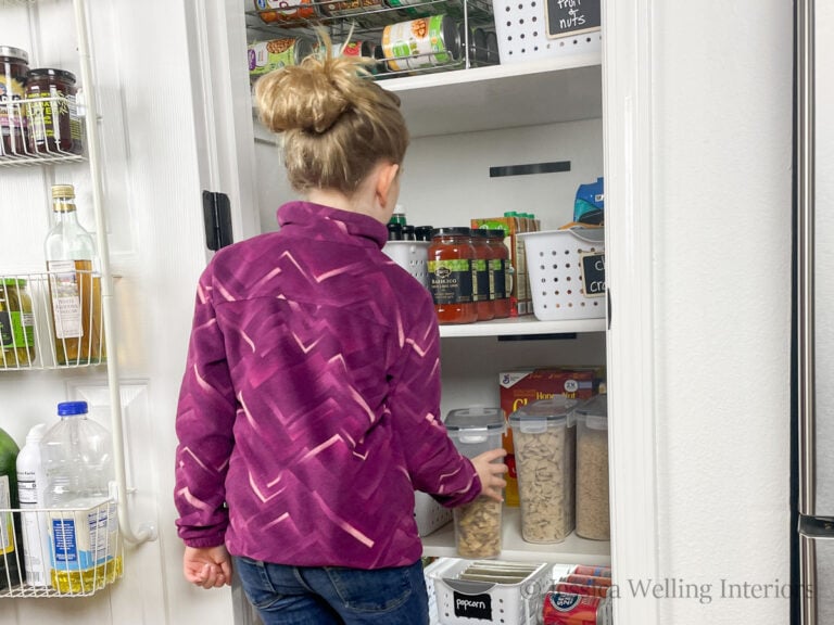 girl putting a container away in a deep pantry