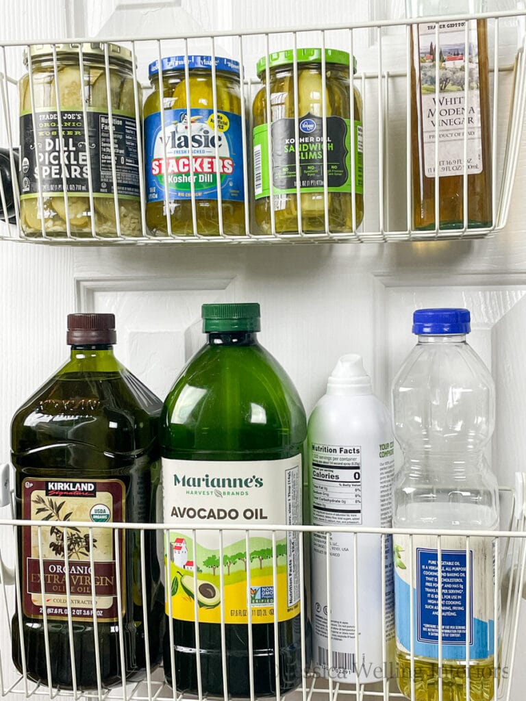 back-of-the-door pantry organizer with bottles of olive oil and pickles