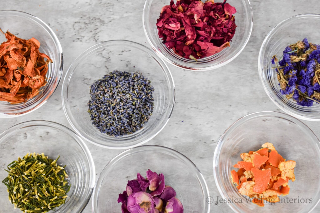 bath salt add-ins in glass bowls on a countertop- rose petals, lavender buds, bits of orange peel, etc.