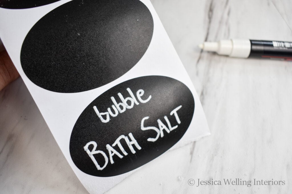 close-up of a chalkboard sticker label with the words, "bubble bath salt" written in white paint pen