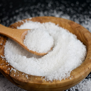 bowl of Dead Sea bath salts with a wood scoop