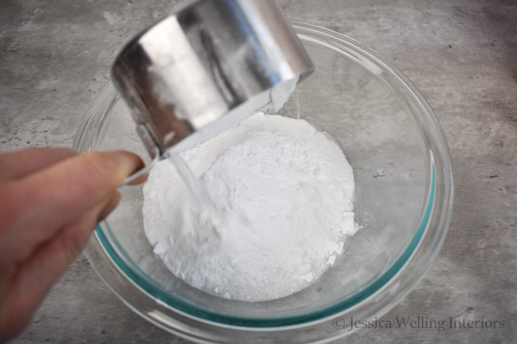 fizzy bath salt ingredients being poured into a mixing bowl