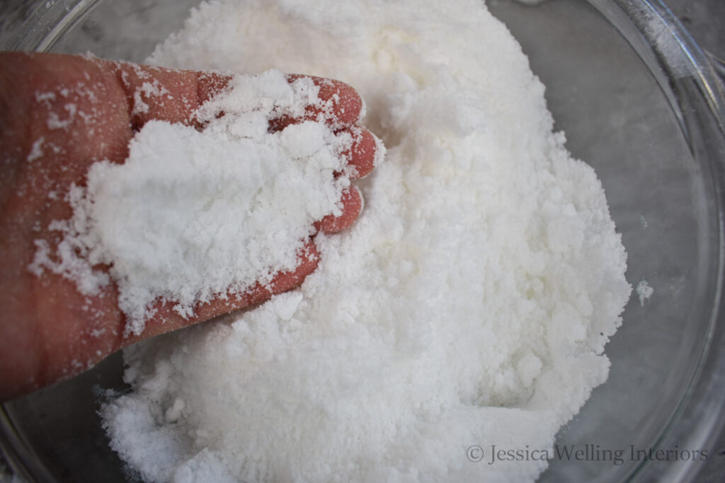 hand in a bowl of homemade bath salts