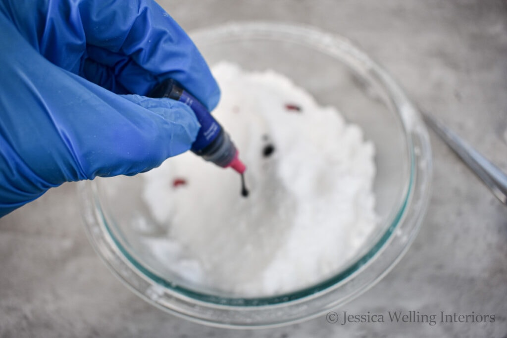 food coloring being added to a bowl of homemade fizzy bath salt