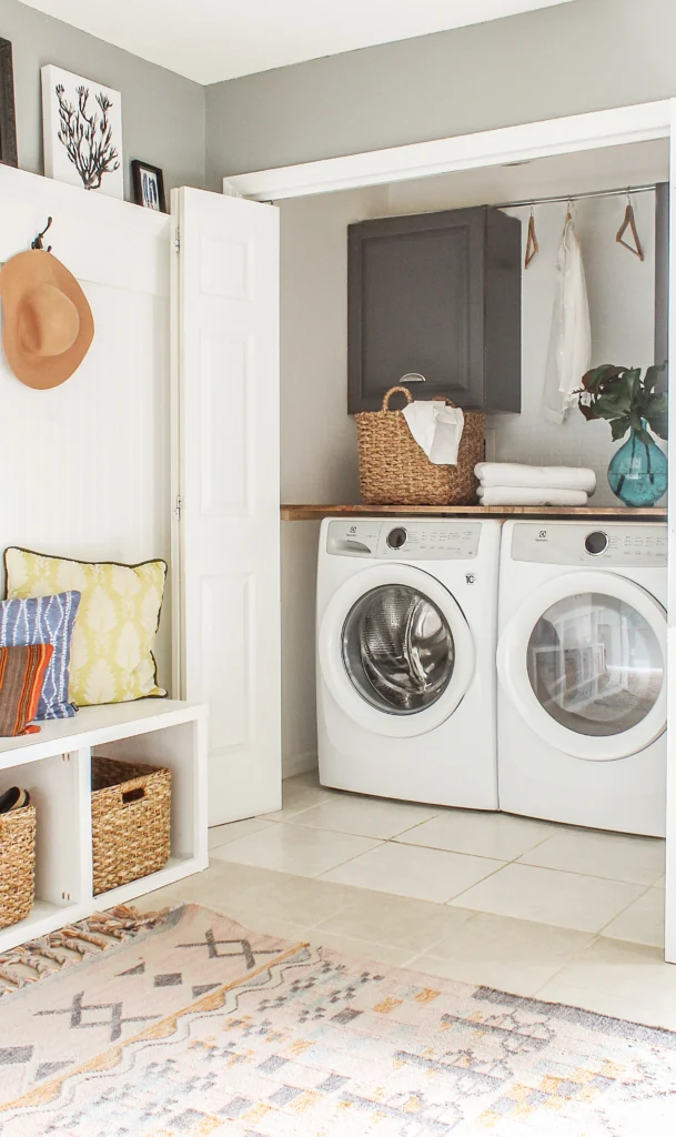 laundry closet with a washer and dryer, storage cabinets, and a countertop