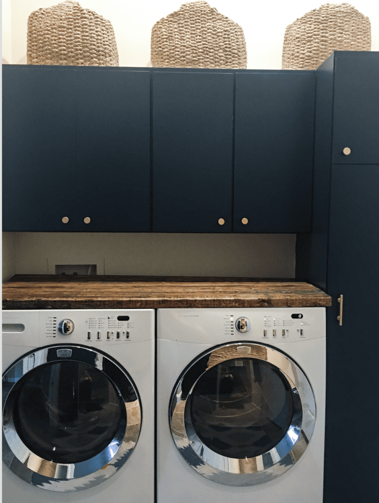 laundry room  with a DIY counter and navy blue cabinets