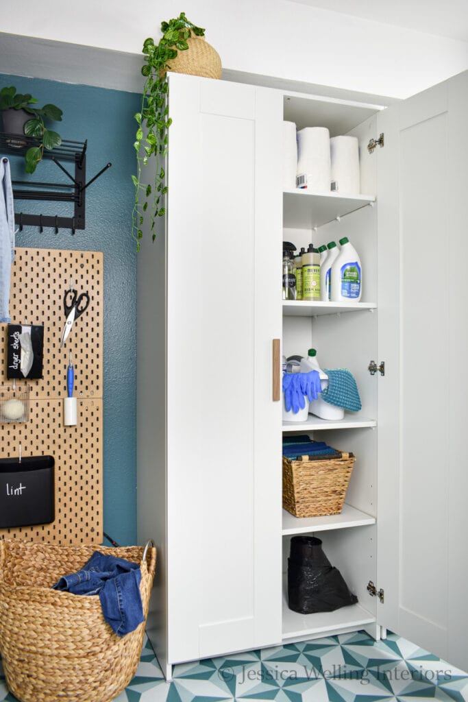 ikea Brimnes wardrobe with added shelves full of cleaning supplies in a small laundry room