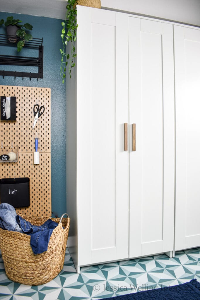 small laundry room with ikea BRIMNES cabinets and a wall-mounted pegboard