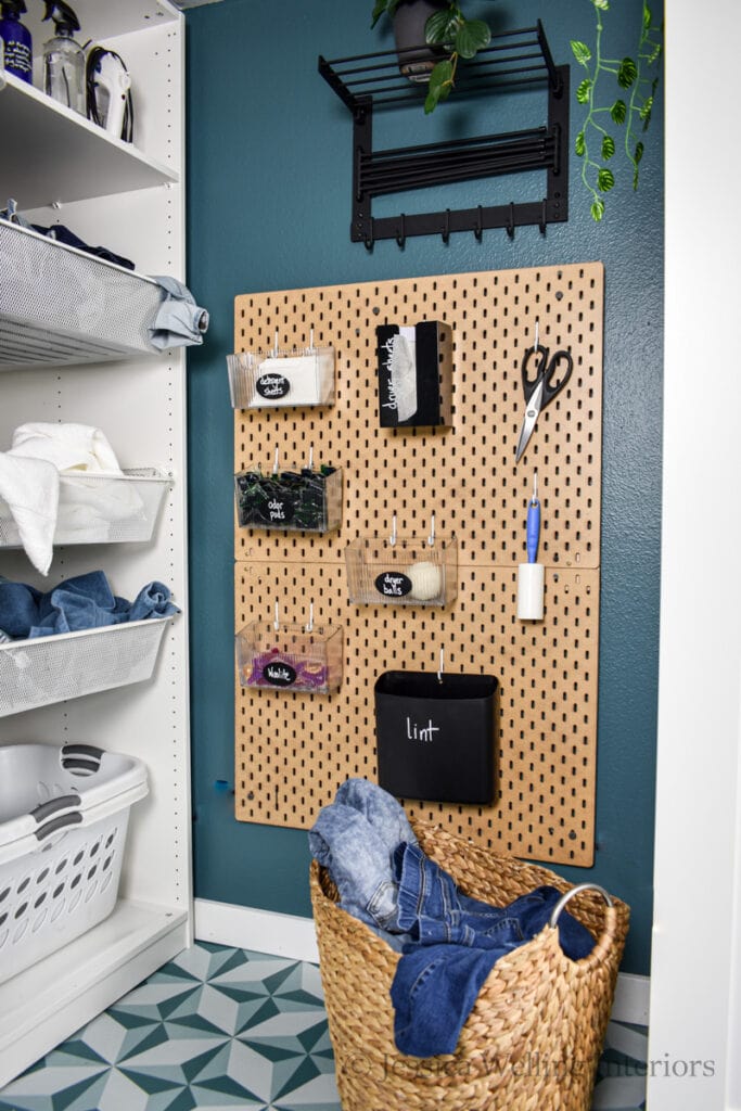 laundry room pegboard with a lint bin, lint roller, scissors, dryer sheets and detergent pod bins