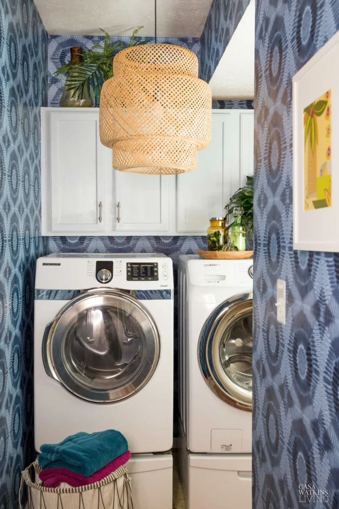 modern Boho laundry room with front load washer and dryer on pedestals